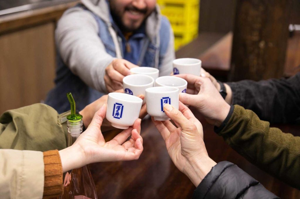 Sake tasting cheers during a tour.