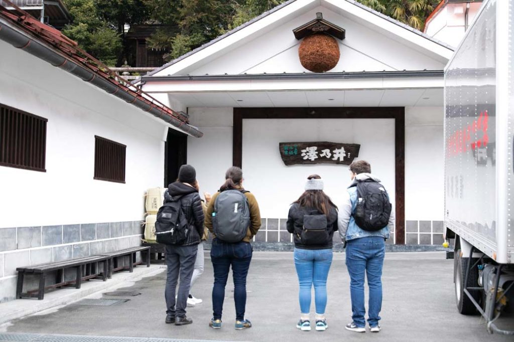 A group of travellers on a sake brewery tour